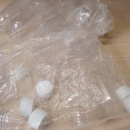 Transparent PET plastic bottles, often used as portable 100ml containers for shampoo or travel kits.#6885