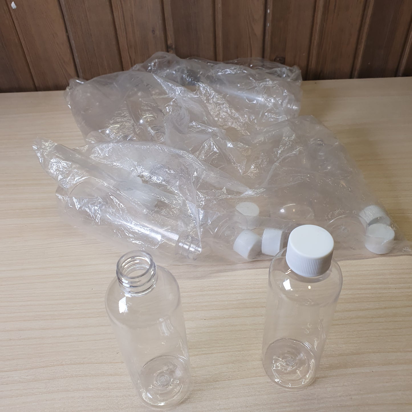 Transparent PET plastic bottles, often used as portable 100ml containers for shampoo or travel kits.#6885