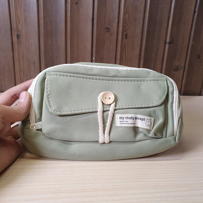 green pencil case features a beige button and white rope accent closure.#8247