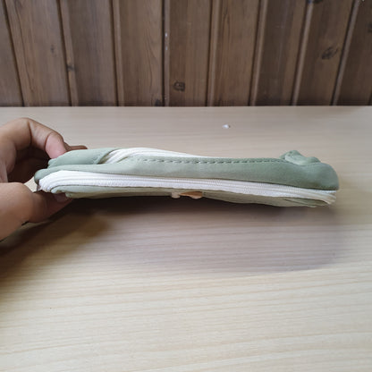 green pencil case features a beige button and white rope accent closure.#8247