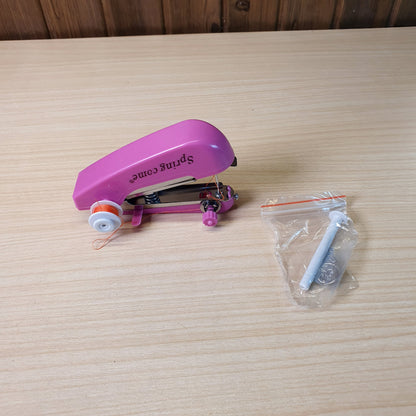 Spring Come brand handheld, portable sewing machine designed for quick repairs and DIY projects. #9289