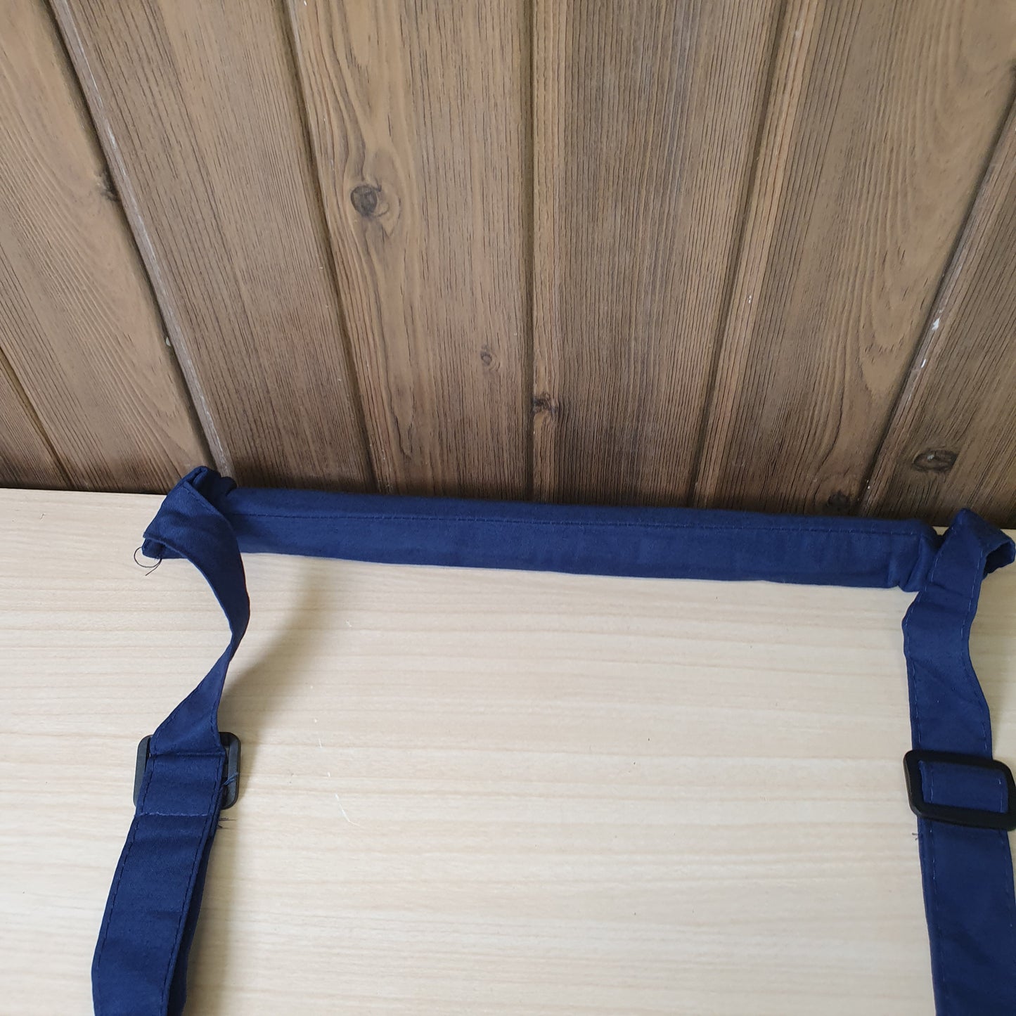 Blue baby walking assistant harness features adjustable straps and embroidered text. # 9273