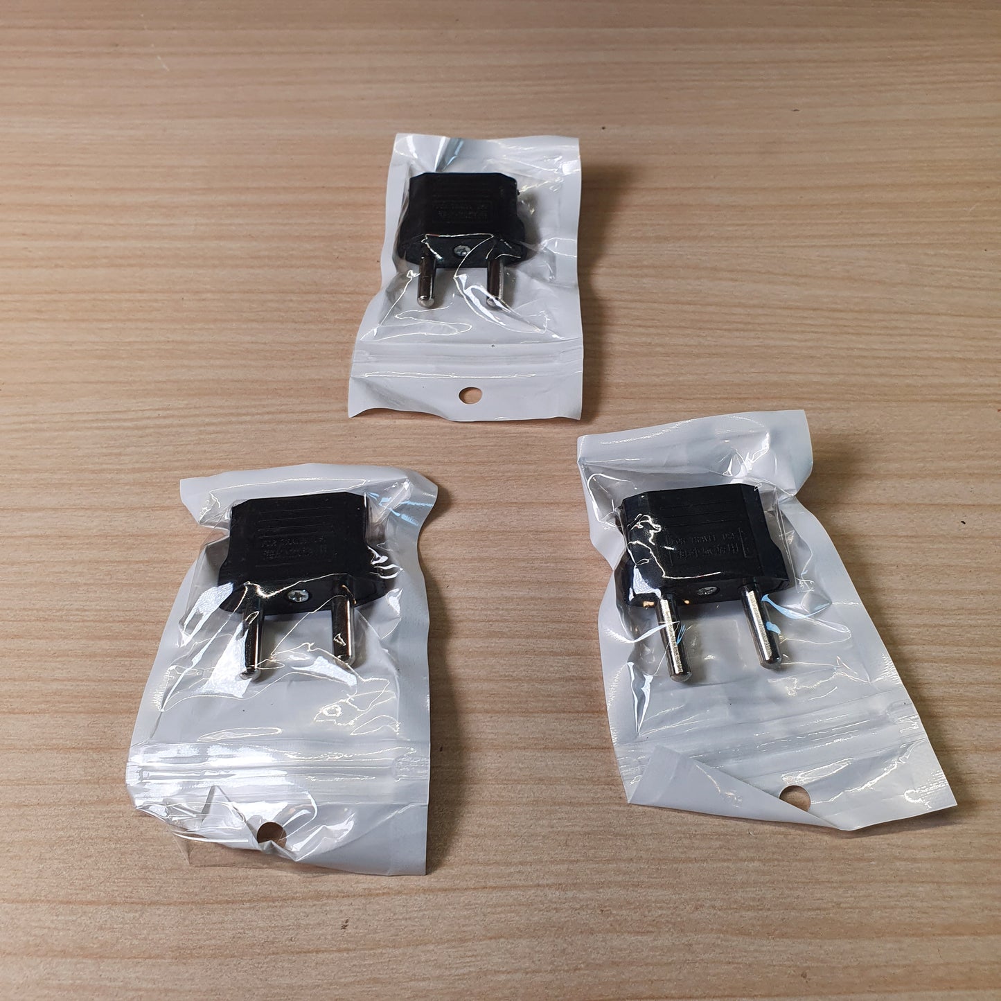 European travel adapter designed to convert American flat-pin plugs to European round-pin sockets. #9147