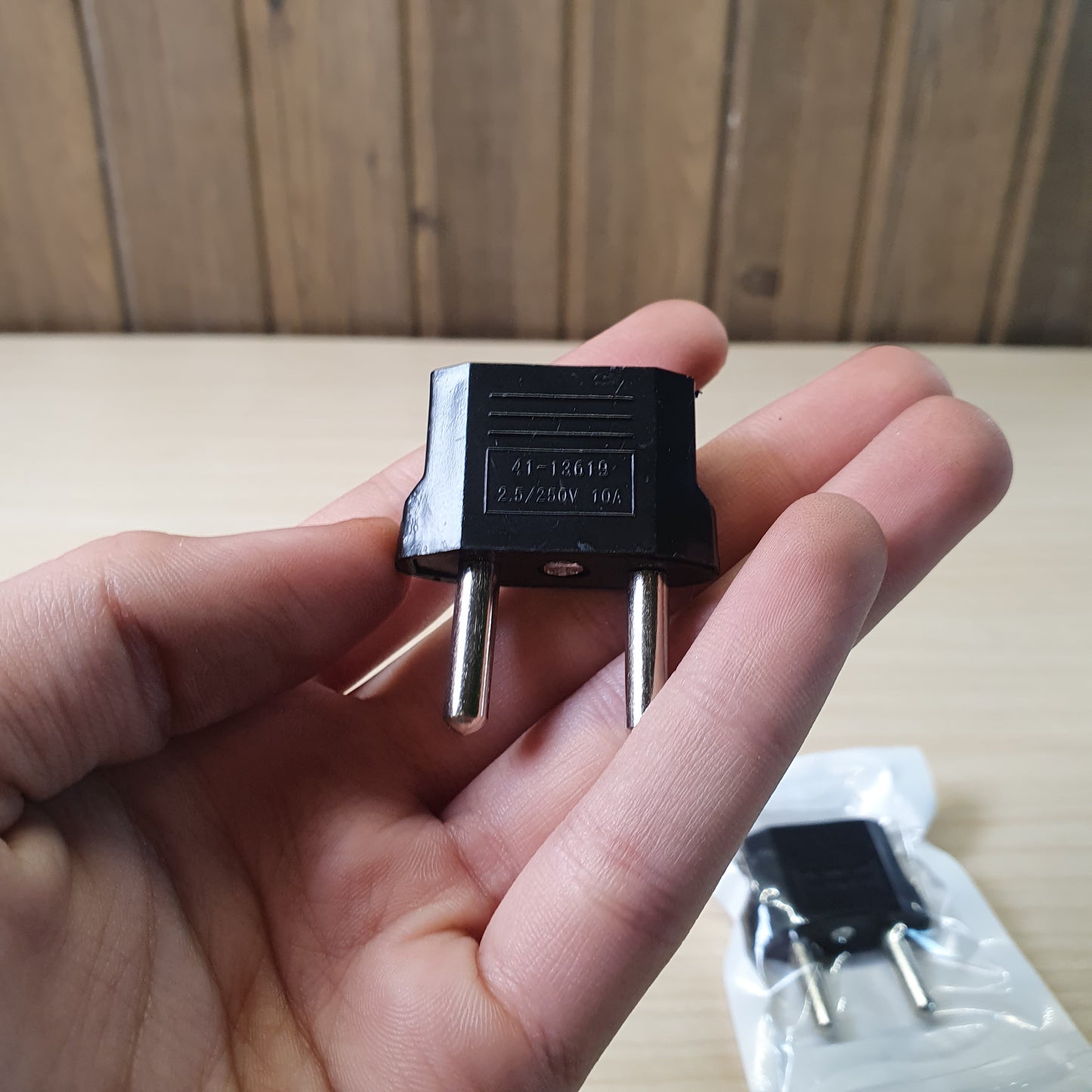 European travel adapter designed to convert American flat-pin plugs to European round-pin sockets. #9147