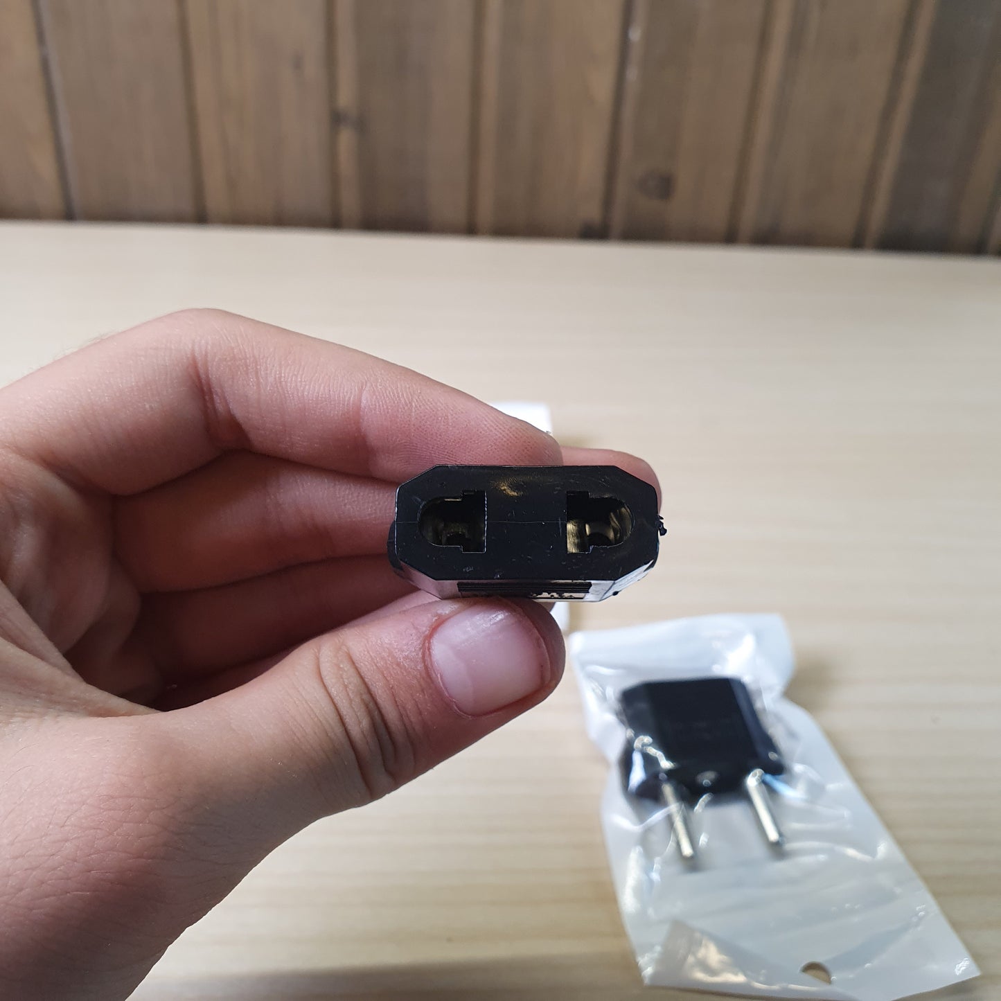 European travel adapter designed to convert American flat-pin plugs to European round-pin sockets. #9147