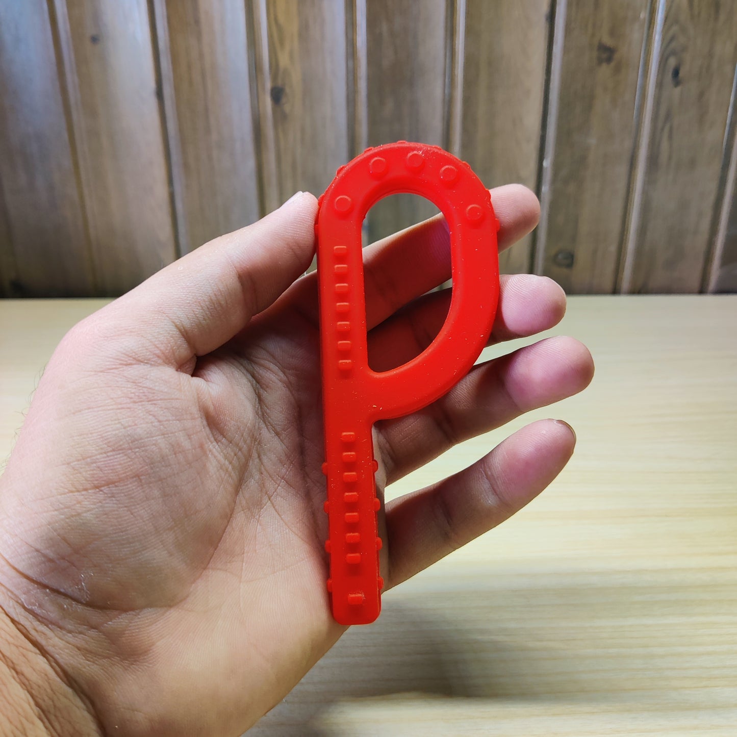Red P-shaped Chewy Tube oral motor tool.#2538