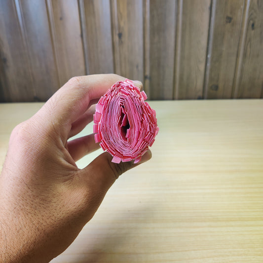 Roll of pink honeycomb packaging paper used for protective cushioning.#2609