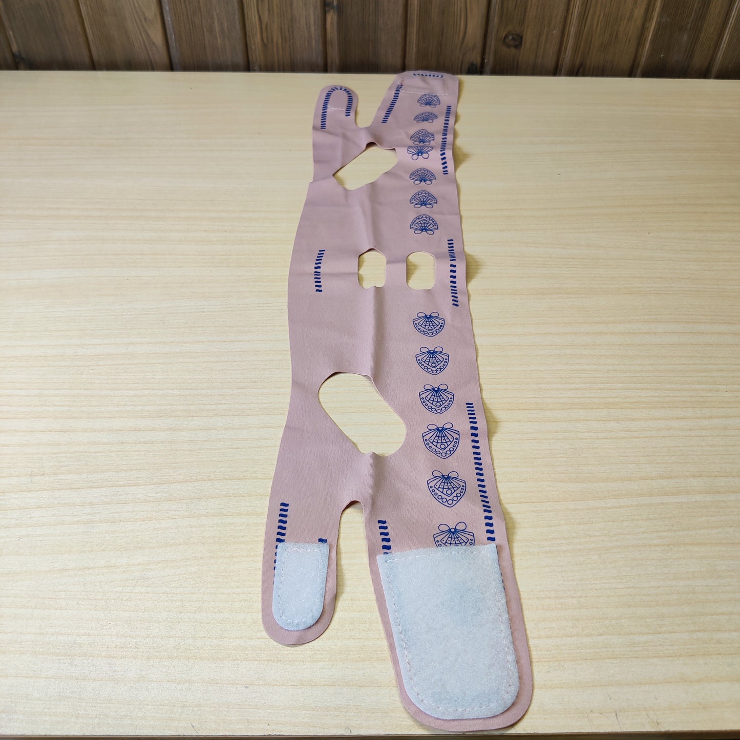 face lifting strap designed to act as a double chin reducer, commonly sold in pink or purple fabric.#4884