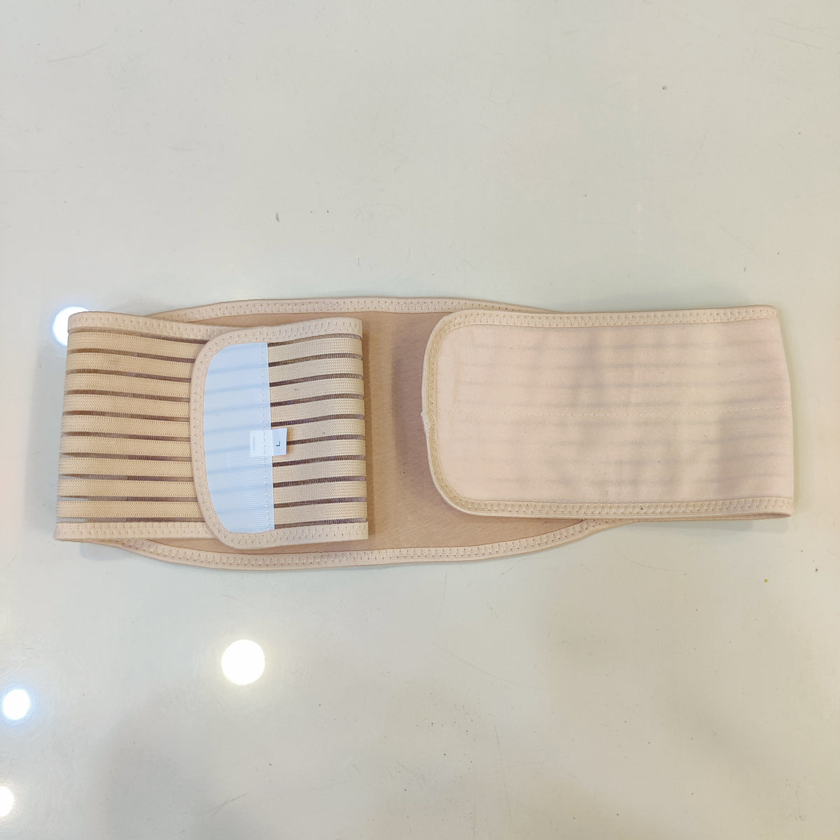 Beige abdominal support belt is designed for postnatal recovery or hernia relief. #9218